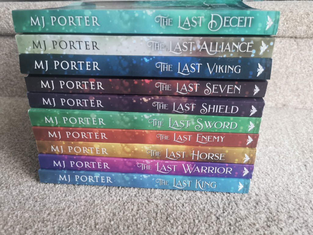 Image shows all 10 books in The Last King series piled up on top of each other. 