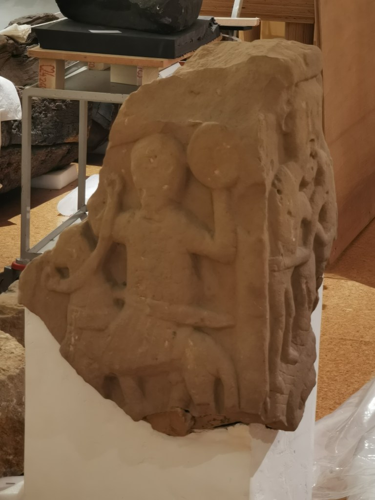 The Repton Stone displayed at Derby Museum. The image shows a carbed image of a mounted warrior, believed to be King Æthelbald of Mercia.
